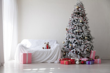 Christmas tree in the room with gifts and decor-new year Festival