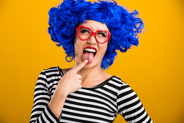 woman with blue wig touching her tongue