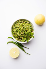 Hot and spicy green chilli chutney using hari mirch, cumin seeds, lemon juice and coriander. served in a bowl. selective focus
