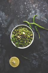 Hot and spicy green chilli chutney using hari mirch, cumin seeds, lemon juice and coriander. served in a bowl. selective focus