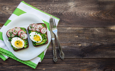 Toasts with avocado, eggs, radish and green onion