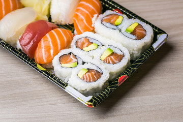 Sushi and Sashimi rolls. Fresh made Sushi set with salmon, prawns, wasabi and ginger. Traditional Japanese cuisine