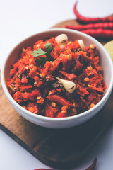 Hot and spicy Hot chilli chutney using lal mirch, cumin seeds, lemon juice and coriander. served in a bowl. selective focus