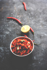 Hot and spicy Hot chilli chutney using lal mirch, cumin seeds, lemon juice and coriander. served in a bowl. selective focus