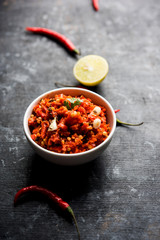 Hot and spicy Hot chilli chutney using lal mirch, cumin seeds, lemon juice and coriander. served in a bowl. selective focus