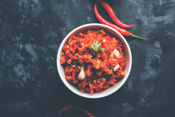 Hot and spicy Hot chilli chutney using lal mirch, cumin seeds, lemon juice and coriander. served in a bowl. selective focus