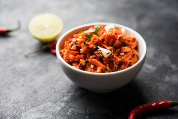 Hot and spicy Hot chilli chutney using lal mirch, cumin seeds, lemon juice and coriander. served in a bowl. selective focus