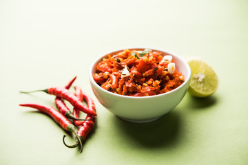 Hot and spicy Hot chilli chutney using lal mirch, cumin seeds, lemon juice and coriander. served in a bowl. selective focus