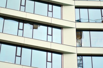 Facade fragment of a modern office building. Exterior of glass wall with abstract texture.