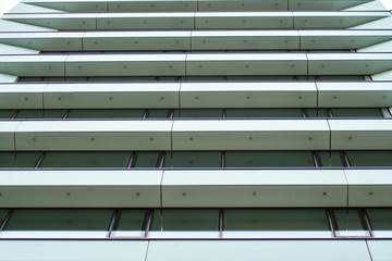 Facade fragment of a modern office building. Exterior of glass wall with abstract texture.