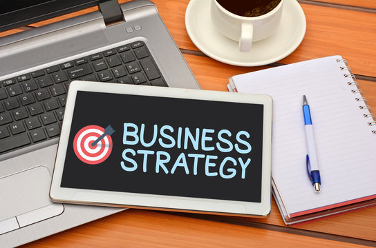 Business Strategy word with tarket icon on tablet