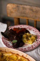 Beef cheeks in red wine with carrots and potato gratin.