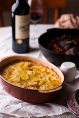 Beef cheeks in red wine with carrots and potato gratin.