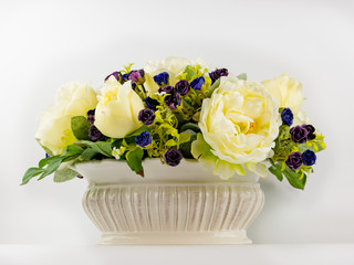 imitation of natural flowers on a white background in porcelain pots