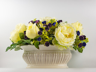 imitation of natural flowers on a white background in porcelain pots