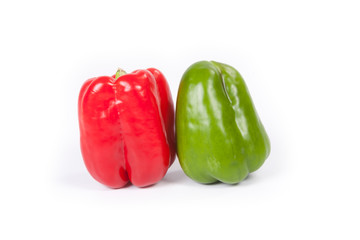 Red and green bell peppers on white background