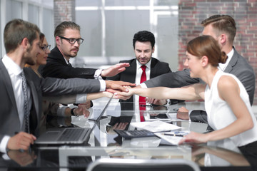 business colleagues working in the office, holding hands together