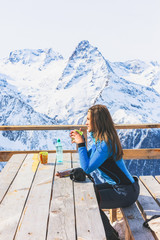 Woman in a cafe at a ski resort.
