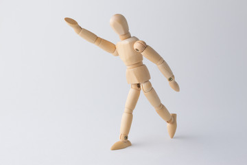wooden figure doll with hand above