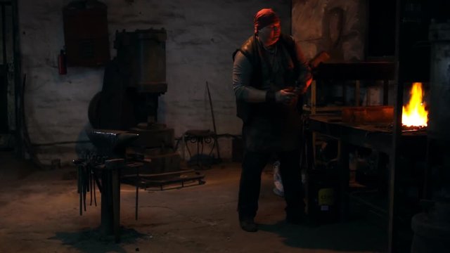 Blacksmith works in the forge