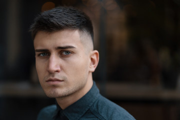 Young man close up portrait with lights in background