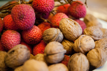 lychee and nuts on wooden background