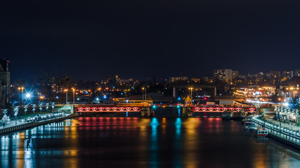 Fototapeta na wymiar CITY AT NIGHT - Ship on the river, boulevards and landscape of Szczecin in the night illumination