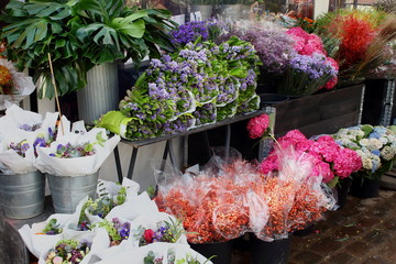 A lot of colorful bright beautiful varied bouquets of flowers on the counter of the farmers market before February 14, Valentine's Day
