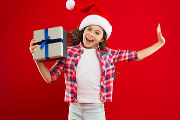 Christmas shopping. Little girl child in santa hat. Present for Xmas. Childhood. New year party. Santa claus kid. Happy winter holidays. Small girl. Love is in the air. happiness.