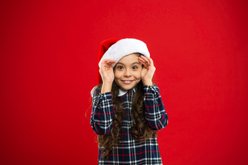 Christmas shopping. Little girl child in santa red hat. Present for Xmas. Childhood. New year party. Santa claus kid. Happy winter holidays. Small girl. Christmas composition. playful mood