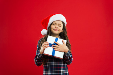 Little girl child in santa red hat. Christmas shopping. New year party. Santa claus kid. Christmas Sales. Present for Xmas. Childhood. Happy winter holidays. Small girl