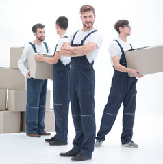 Obraz premium The team of responsible movers and their smiling leader,