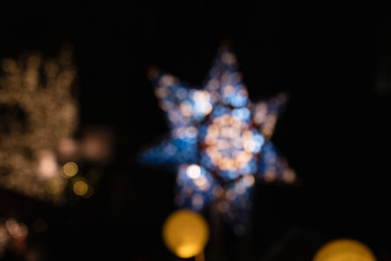 Blurry bokeh star shaped lights in dark night at lantern procession of Nuremberg's school kids at...