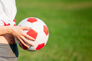 soccer ball in hand. copy space. close-up. football game concept.