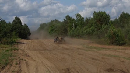 Armored vehicles crossing training area during training exercise