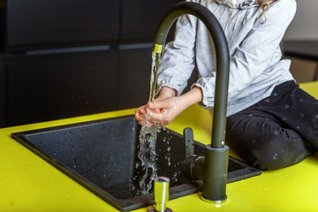 Little girl with chef hat learning cooking smiling in kitchen. Kid preparing healthy food at home and having fun. Childhood, food, healthy eating, household, teamwork, helping, family concept Close up