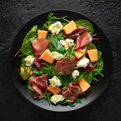 Parma ham and melon salad with mozzarella, green leaves mix