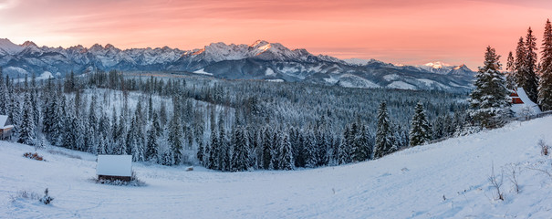 Winter Tatra mountains wide panorama with wooden hut at dawn