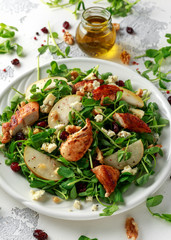 Pear, chicken salad with blue cheese, cranberry and walnuts. concept healthy food