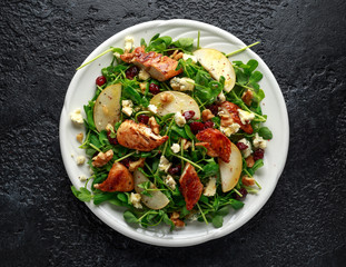 Pear, chicken salad with blue cheese, cranberry and walnuts. concept healthy food. black background
