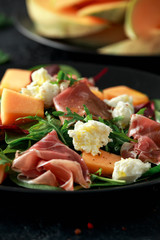 Parma ham and melon salad with mozzarella, green leaves mix