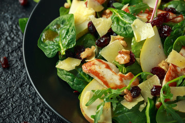 Grilled Halloumi Cheese salad with peach fruit, nuts and spinach, arugula mix. healthy food