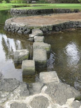 Stepping Stones Over Water In A Japanese Garden