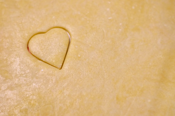 Obraz premium Cooki heart on rolled dough