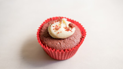 Close up of a red velvet cup cake with Cream Cheese frosting