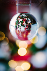 crystal ball reflecting a Christmas tree with lights