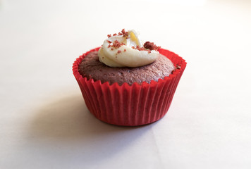 Close up of a red velvet cup cake with Cream Cheese frosting