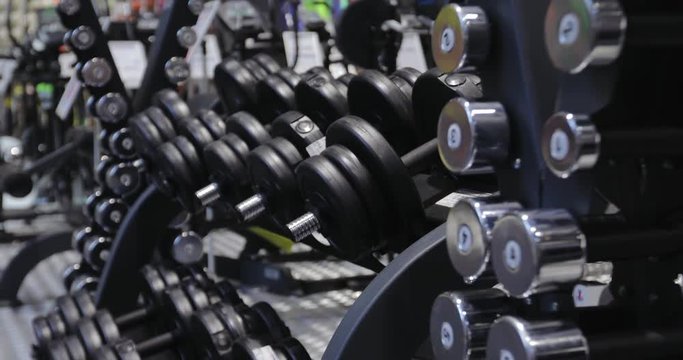 Сollection, warehouse of new dumbbells in a sports store, sale, fitness training