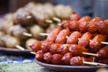 Mini sausages on wooden skewers. Delicious food.