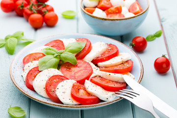 Classic caprese salad. Mozzarella tomatoes and  Basilikum.